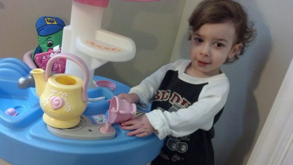 Standing and playing at our new kitchen, we love it making tea.