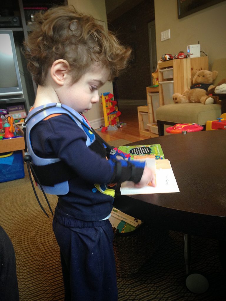 Opting to leave it on after his sippy is finished, Aleck reads in our living room.