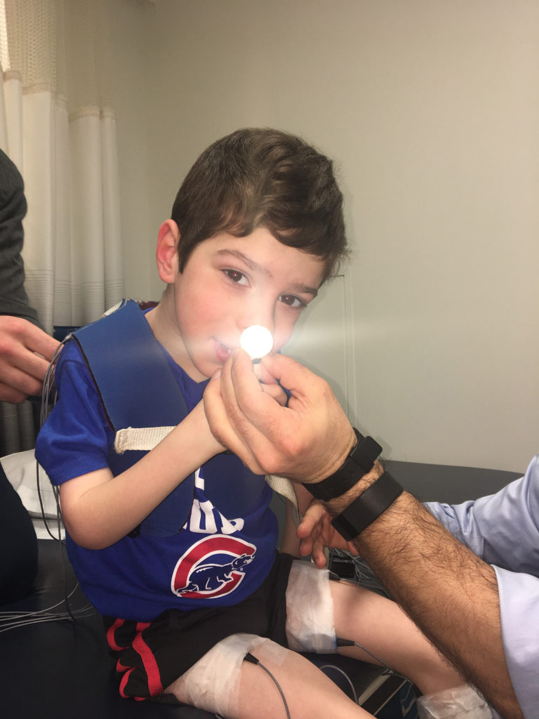 Showing Aleck how the gear works to keep him interested. 